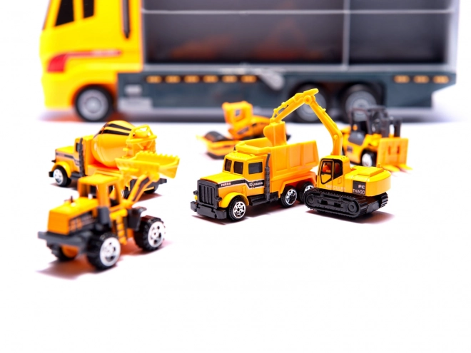 Camion avec petits véhicules de construction