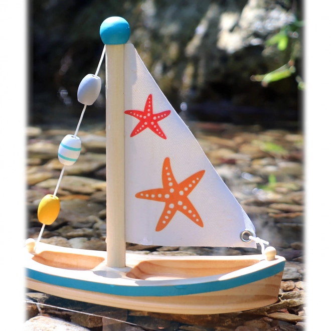 Petit bateau à voile en bois étoile de mer